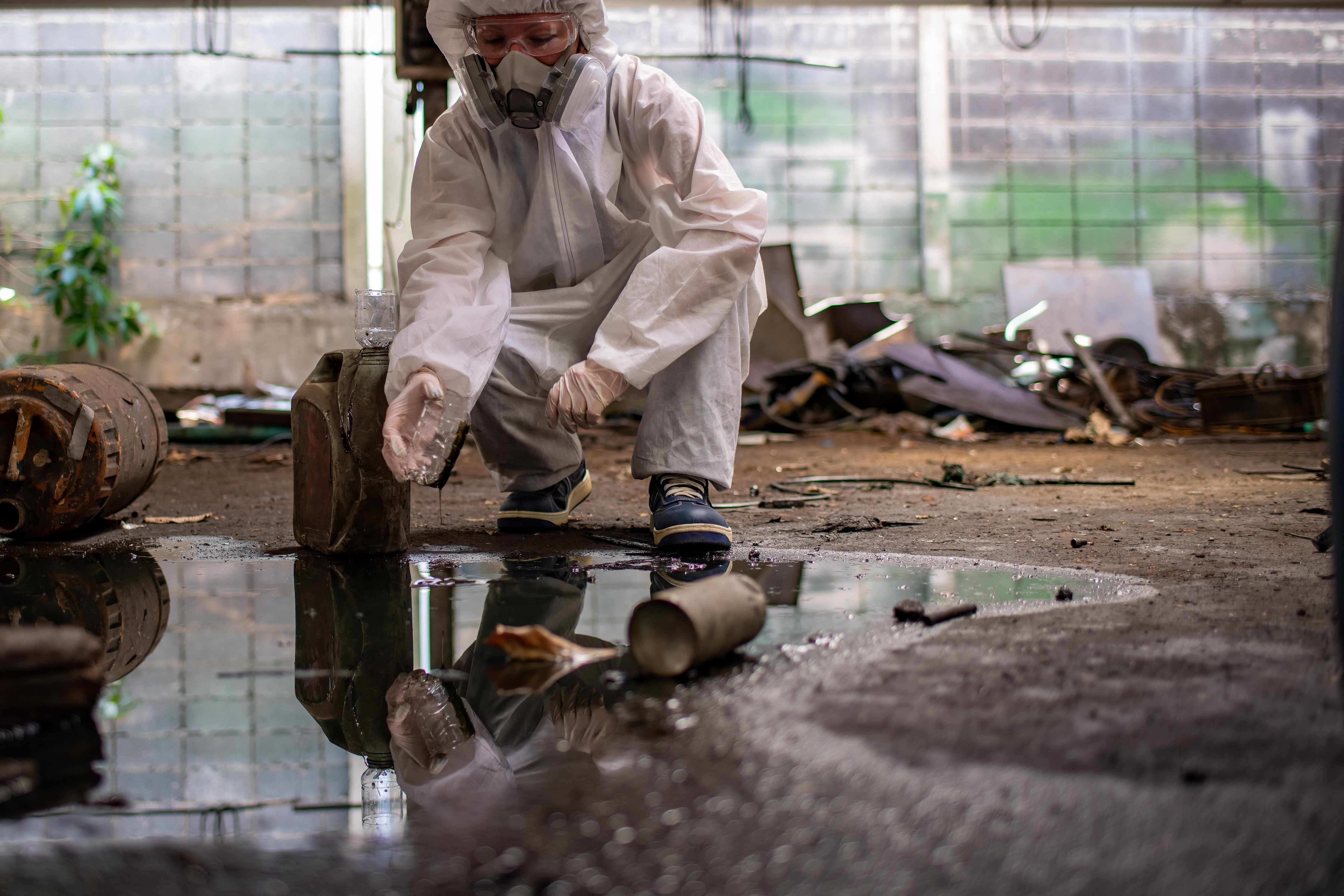 worker-wearing-safety-uniform-and-gas-mask-they-us-2025-03-14-11-24-52-utc